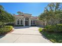 Inviting single story home with a red tile roof, neutral paint, manicured landscaping and a circular driveway at 901 Reflection Way, Osprey, FL 34229