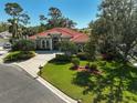 Charming home featuring lush lawn, mature trees, decorative landscaping and a brick-lined driveway and walkway at 901 Reflection Way, Osprey, FL 34229