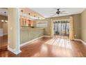 Bright living space features wood floors, columns, bar area with sliding door to backyard at 919 80Th Nw St, Bradenton, FL 34209
