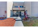 Charming townhome facade with a welcoming front porch, complete with seating and lovely landscaping at 1026 Longfellow Ct # 111, Sarasota, FL 34243