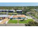 Charming light-blue single-story home with lush lawn, palm trees and nearby canal access at 10304 Sandpiper W Rd, Bradenton, FL 34209
