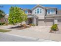 Attractive townhome with a covered entry, brick-paved driveway, and manicured landscaping at 11925 Brookside Dr, Bradenton, FL 34211