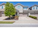 Inviting townhome with a two-car garage, stone accents, and well-maintained landscaping at 11925 Brookside Dr, Bradenton, FL 34211