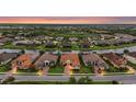 Aerial view of a luxury community with waterfront homes, manicured lawns and mature trees at 12020 Legacy Estates Blvd, Sarasota, FL 34238