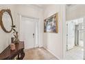 Inviting foyer with tile flooring, white door, and attractive decor at 12210 Goldenrod Ave, Bradenton, FL 34212