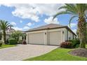 Side view of garage highlighting a two-car garage with brick paver driveway at 12210 Goldenrod Ave, Bradenton, FL 34212
