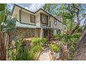Charming two-story townhome featuring well-manicured landscaping and an inviting entrance at 1490 Mahogany Ln # 706, Palm Harbor, FL 34683