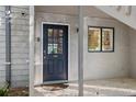 Close-up of front door and windows with a tile porch, offering a welcoming entrance to the home at 1621 Boathouse Cir # 125, Sarasota, FL 34231