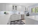 Bright kitchen featuring white cabinets, modern stainless steel appliances, and ample counter space at 1621 Boathouse Cir # 125, Sarasota, FL 34231