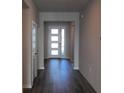 Inviting entryway featuring wood-look floors and a modern front door with sidelights at 17041 James Trl, Parrish, FL 34219