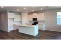 Bright kitchen features an island with marble counters, stainless appliances, and plenty of cabinet space at 17041 James Trl, Parrish, FL 34219