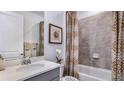 Cozy bathroom with shower-tub combo, modern vanity, stylish decorative accents, and a neutral color palette at 17917 Tavernside Trl, Lakewood Ranch, FL 34211