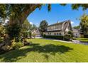Beautifully landscaped front yard leads to the charming Tudor-style home with manicured hedges at 1829 Bougainvillea St, Sarasota, FL 34239