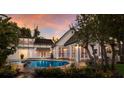 A beautiful backyard pool area that features an in-ground pool, stone deck and lush landscaping at 1829 Bougainvillea St, Sarasota, FL 34239