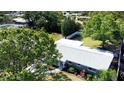 An aerial view of a well-maintained single story house, surrounded by lush greenery at 2238 Rose St, Sarasota, FL 34239