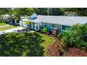 Well-kept single-story home with lush landscaping, green lawn, and charming curb appeal at 2238 Rose St, Sarasota, FL 34239