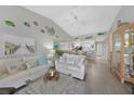 Open-concept living room with nautical decor, tile floors, and lots of natural light at 245 Coldeway Dr # B10, Punta Gorda, FL 33950