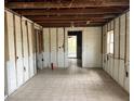 Spacious room with tile flooring and exposed beams, ready for customization and renovation at 29 Michiana Dr, Terra Ceia, FL 34250