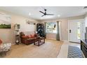 Inviting living room with large window, ceiling fan, and a comfortable leather sofa at 2922 Williamsburg St, Sarasota, FL 34231