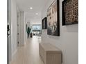 Hallway featuring a decorative bench and modern art leading to an outdoor view at 301 Quay Commons # 1204, Sarasota, FL 34236