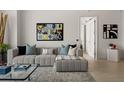 Cozy living room showcasing a modern sectional sofa, stylish rug, and artistic wall decor at 301 Quay Commons # 1204, Sarasota, FL 34236