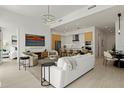 Spacious living room with modern decor, a stylish chandelier, and a seamless open floor plan at 301 Quay Commons # 507, Sarasota, FL 34236