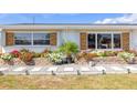 Landscaped front yard features brick planters filled with flowers and a stone walkway to the home at 309 Glen Oak Rd, Venice, FL 34293