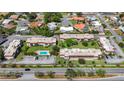 Aerial view of condo complex with well-maintained grounds, a central pool, and surrounding residential neighborhood at 3606 Beneva Rd # 506, Sarasota, FL 34232