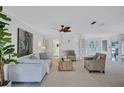 Spacious living room featuring neutral paint, stylish ceiling fan, and comfortable seating arrangement, perfect for entertaining at 4487 Glebe Farm Rd, Sarasota, FL 34235