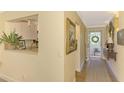 Well-decorated hallway with a view into the kitchen and an exterior door leading to a porch at 4489 Longmeadow # 74, Sarasota, FL 34235