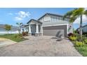 A well-kept home boasting a brick driveway, tidy lawn, and vibrant landscaping at 4725 Antrim Dr, Sarasota, FL 34240