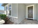 Inviting front entrance features stone accents, neutral paint and brick pathway at 4725 Antrim Dr, Sarasota, FL 34240