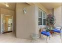 Inviting outdoor seating area with comfortable chairs and a side table at 5320 Hyland Hills Ave # 2214, Sarasota, FL 34241