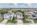 Scenic aerial view of the neighborhood showcasing the surrounding pond and lush greenery at 5426 Rainwood Meadows Dr, Apollo Beach, FL 33572