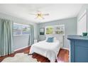 Cozy bedroom with hardwood floors, ceiling fan and natural light at 5675 Saint Louis Ave, Sarasota, FL 34233