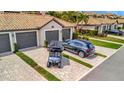 Charming exterior view of home featuring grey driveway and a golf cart at 5694 Palmer Cir # 202, Bradenton, FL 34211