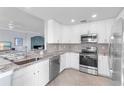 Modern kitchen features stainless steel appliances, granite countertops, and ample cabinet space at 6618 Grand Estuary Trl # 101, Bradenton, FL 34212