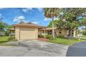 Single story home with a one-car garage, neutral paint, brick path and mature landscaping at 7142 Bright Creek Dr # 35, Sarasota, FL 34231