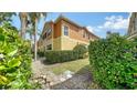 Exterior rear view highlighting the manicured hedges and well-maintained lawn at 7983 Limestone Ln # 14-201, Sarasota, FL 34233