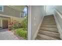 Welcoming foyer featuring wood stairs and view of garden, creating a warm ambiance at 7983 Limestone Ln # 14-201, Sarasota, FL 34233