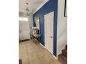 Inviting foyer with tile floors, elegant decor, and a staircase leading to the upper level at 9011 Hammock Edge Pl, Bradenton, FL 34212