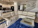 Bright living room features a large sectional couch, fluffy rug, and view of the entryway at 9011 Hammock Edge Pl, Bradenton, FL 34212