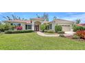 Charming one-story home boasts lush landscaping, mature trees, and a brick walkway leading to the front door at 9238 13Th Avenue Nw Cir, Bradenton, FL 34209