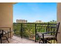 Private balcony with seating offers relaxing views of nearby resort and lush landscaping at 1064 N Tamiami Trl # 1425, Sarasota, FL 34236