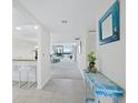 Hallway with tiled floors and light walls leading to the living space and views of the waterfront at 1095 Gulf Of Mexico Dr # 503, Longboat Key, FL 34228
