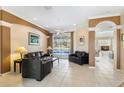 Inviting living room with tile floors, neutral walls, and sliding glass doors leading to the pool at 12005 Summer Meadow Dr, Lakewood Ranch, FL 34202