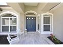 Inviting entryway with double doors, stylish tile flooring, and decorative welcome decor at 15451 27Th E Ct, Parrish, FL 34219