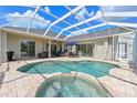 Private screened-in pool area with brick patio, spa, and outdoor seating at 15451 27Th E Ct, Parrish, FL 34219