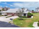 Well-maintained home boasts a two-car garage, lush landscaping, and pristine curb appeal in a desirable location at 1714 Fairway Trce, Palmetto, FL 34221