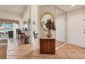 Inviting foyer with tile flooring, a mirrored wall, and decorative accents, leading into the living spaces at 1714 Fairway Trce, Palmetto, FL 34221